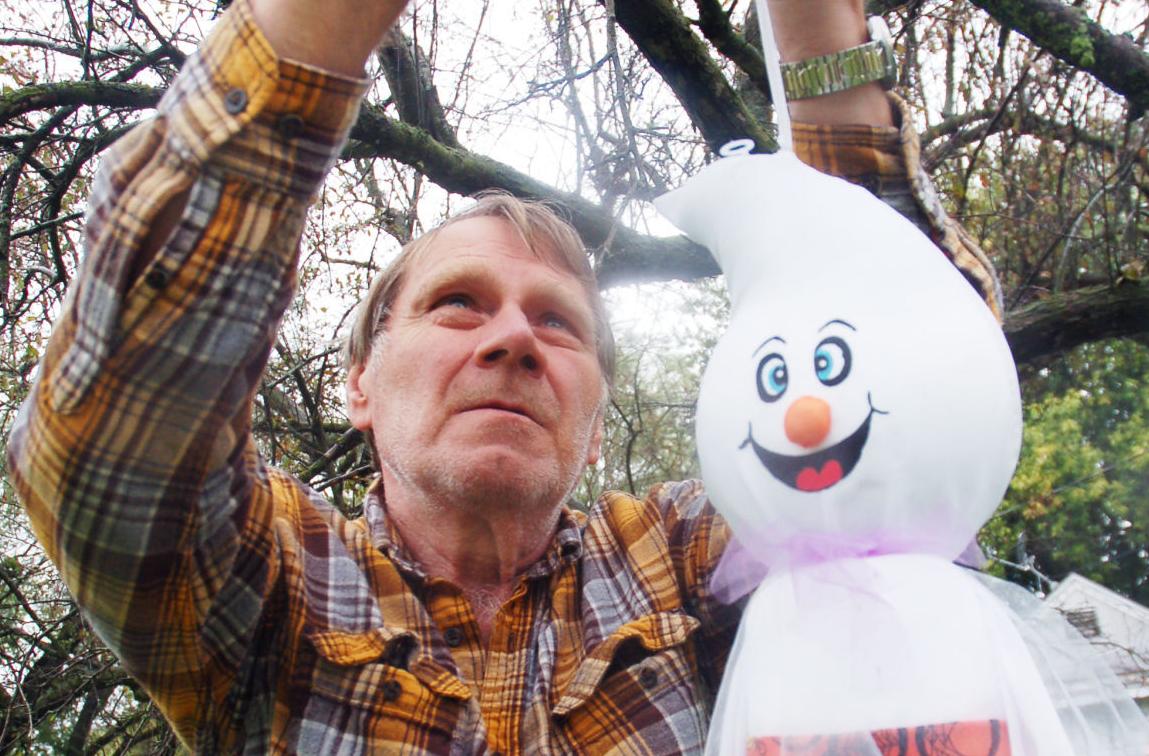 Patrick Macara of Walworth hangs Halloween decorations